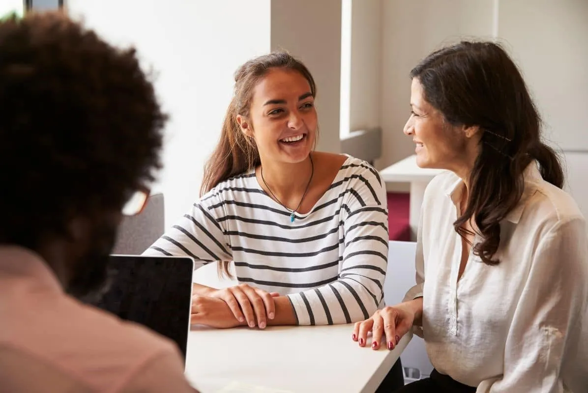 Mother and daughter meeting with a banker to open a new spending account